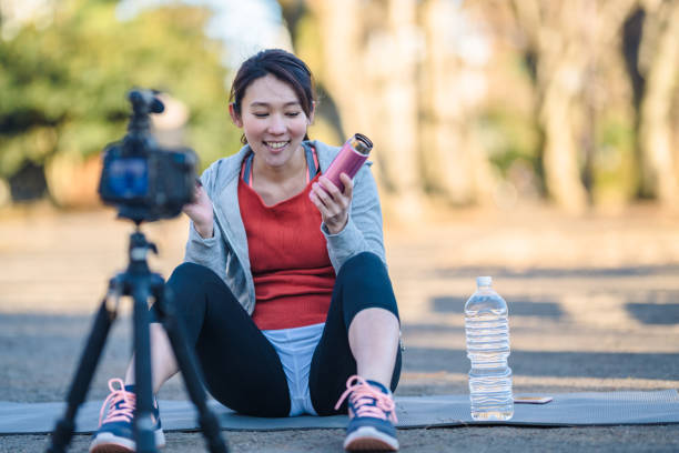istock Sportswoman talking about drinking water for her vlog 1127347164