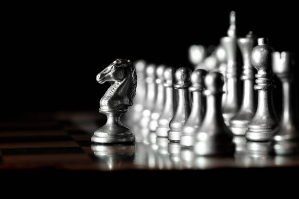 istock Pieces on chess board for playing game and strategy knight kingdom 1127347756