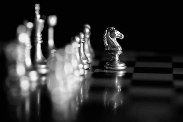 istock Pieces on chess board for playing game and strategy knight kingdom 1127347765