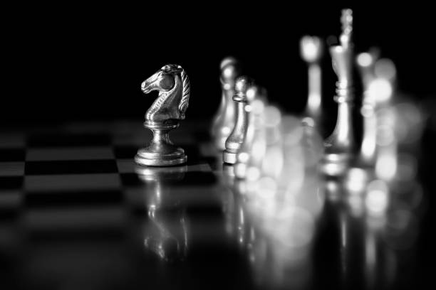 istock Pieces on chess board for playing game and strategy knight kingdom 1127347795