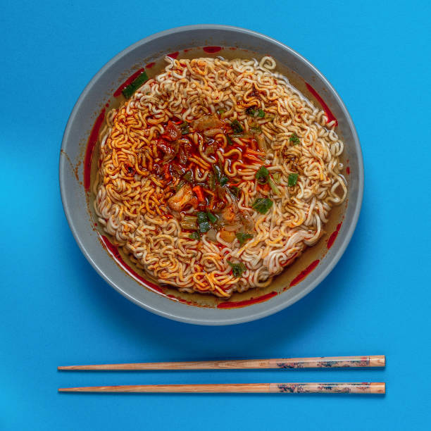 istock cooked instant noodles soup with chopsticks on a blue background with a place for copy space 1127347974
