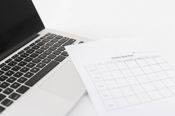istock Meal plan for week on paper and laptop 1127347998