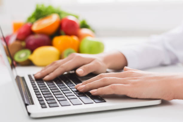 istock dietitian typing treatment to patient via internet 1127348018