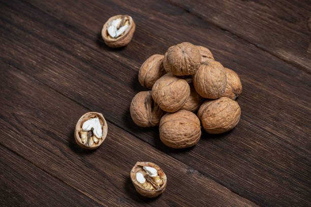 istock Walnuts lie on a wooden background 1127348992