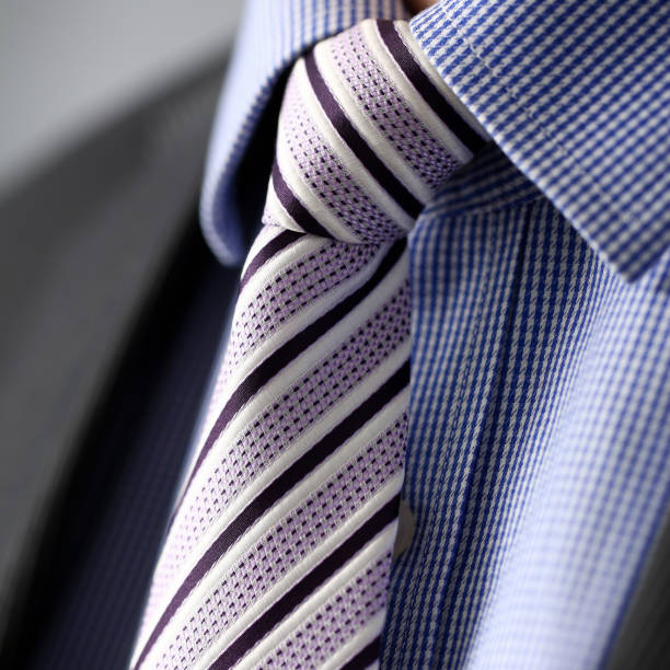 istock Business man in black suit set tie closeup 1127351250