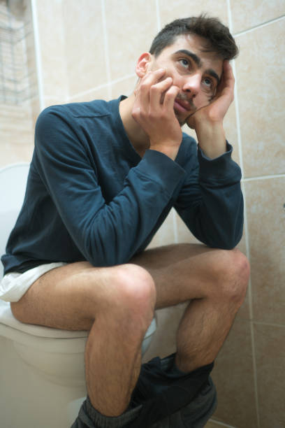 istock Man Sitting In Toilet 1127353348