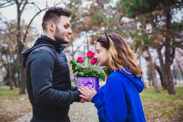 istock Young man gives present to girlfriend 1127353511