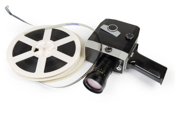Vintage amateur movie camera and reels of Super 8mm films Old vintage amateur film movie camera powered by clockwork motor and reels of color motion picture films Super 8mm format on a white background vintage amateur movie camera stock pictures, royalty-free photos & images