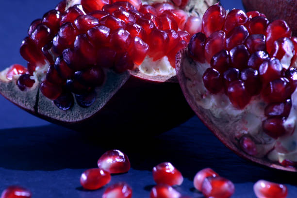 istock Close-up on a red garnet. fruit pieces of pomegranate on a dark background. 1127354657