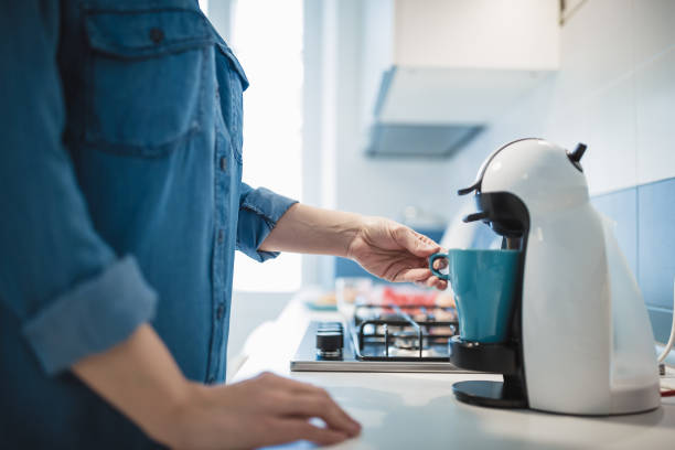 istock Young woman is making her morning coffee in her kitchen 1127355049