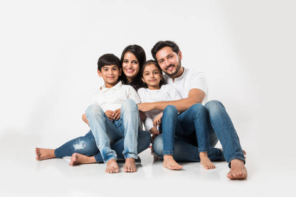 istock Young Indian/asian family sitting isolated over white background. selective focus 1127356305