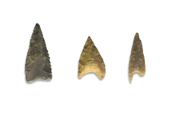 istock Three serrated stone arrowheads. Isolated over white background 1127356485