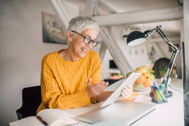 istock Woman with digital tablet smiling 1127356660