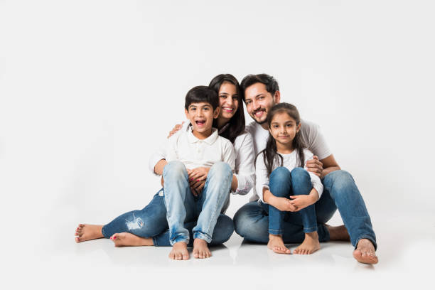 istock Young Indian/asian family sitting isolated over white background. selective focus 1127356866