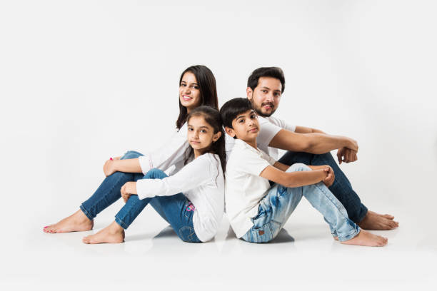 istock Young Indian/asian family sitting isolated over white background. selective focus 1127357068