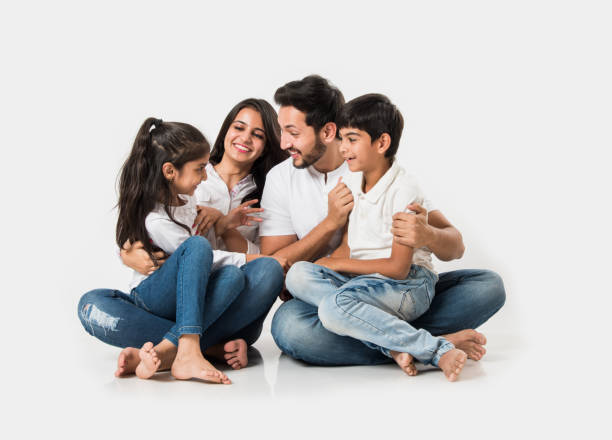 istock Young Indian/asian family sitting isolated over white background. selective focus 1127357178