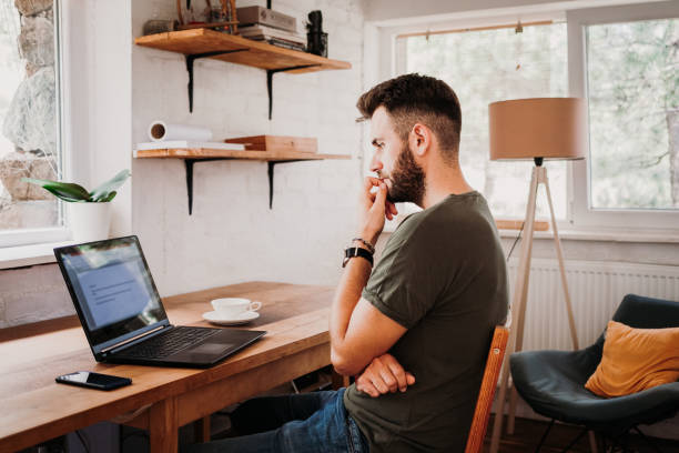 istock Young casual man working on a laptop 1127357195