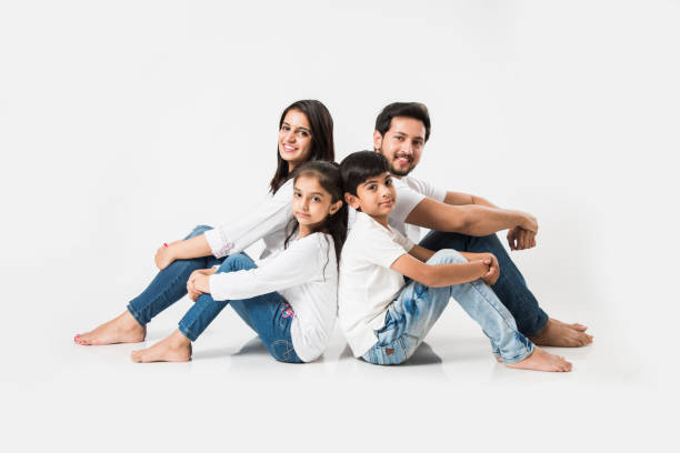 istock Young Indian/asian family sitting isolated over white background. selective focus 1127358502