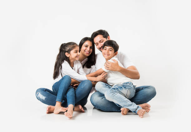 istock Young Indian/asian family sitting isolated over white background. selective focus 1127358550