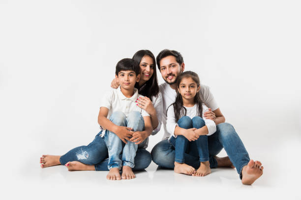 istock Young Indian/asian family sitting isolated over white background. selective focus 1127358574