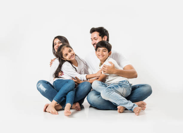 istock Young Indian/asian family sitting isolated over white background. selective focus 1127358620