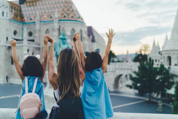 Family trip in Budapest Rear view of mother with daughters enjoying Budapest fishermens bastion photos stock pictures, royalty-free photos & images