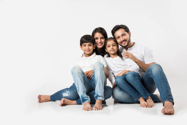 istock Young Indian/asian family sitting isolated over white background. selective focus 1127358780