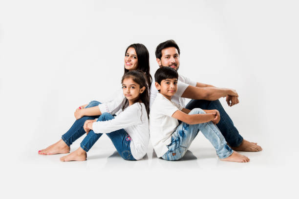istock Young Indian/asian family sitting isolated over white background. selective focus 1127358830