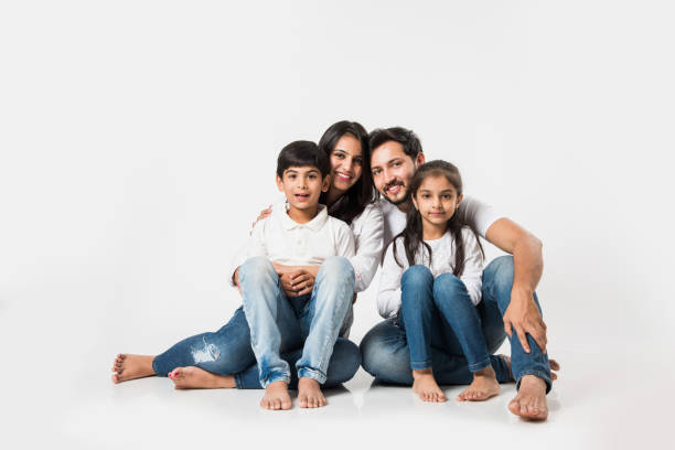 istock Young Indian/asian family sitting isolated over white background. selective focus 1127358857