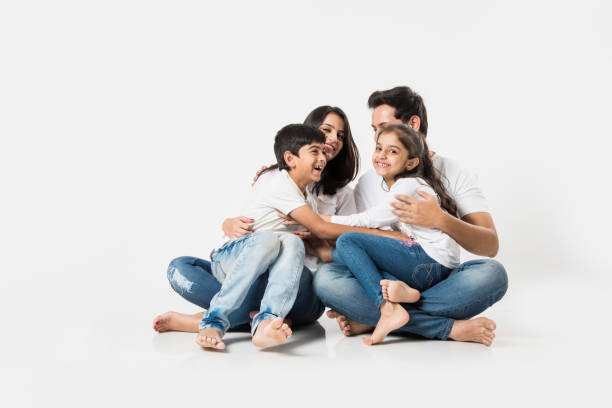 istock Young Indian/asian family sitting isolated over white background. selective focus 1127358936