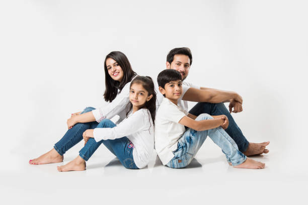istock Young Indian/asian family sitting isolated over white background. selective focus 1127358956