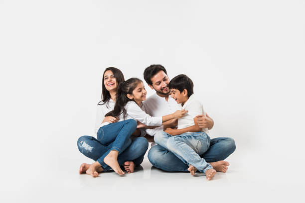 istock Young Indian/asian family sitting isolated over white background. selective focus 1127358983