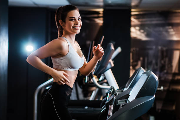 istock Young athletic woman doing cardio training on treadmill. 1127359006