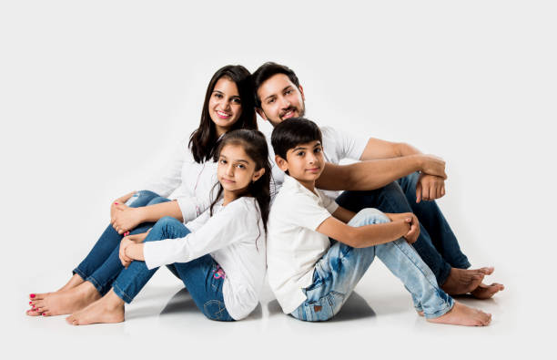 istock Young Indian/asian family sitting isolated over white background. selective focus 1127359039