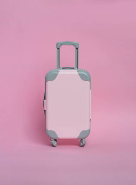 istock Pink suitcase on a pink background. Minimalism 1127360449