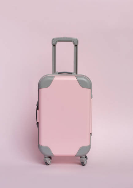 istock Pink suitcase on a pink background. Minimalism 1127360653