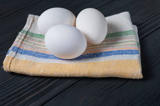 istock fresh white eggs on a black wooden background 1127360835