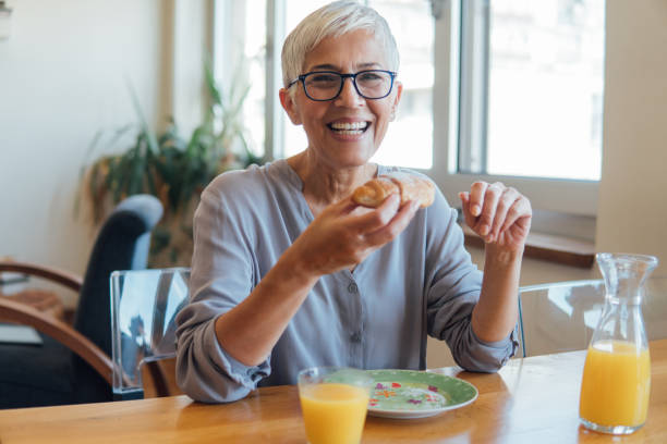 istock Happy woman eating breakfast 1127360913
