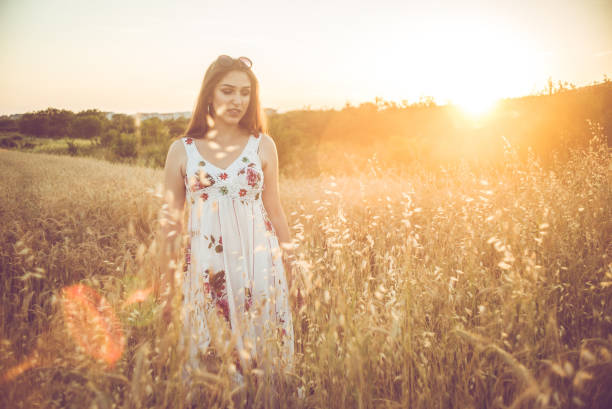 istock A beautiful young woman in the wheat field. 1127361851