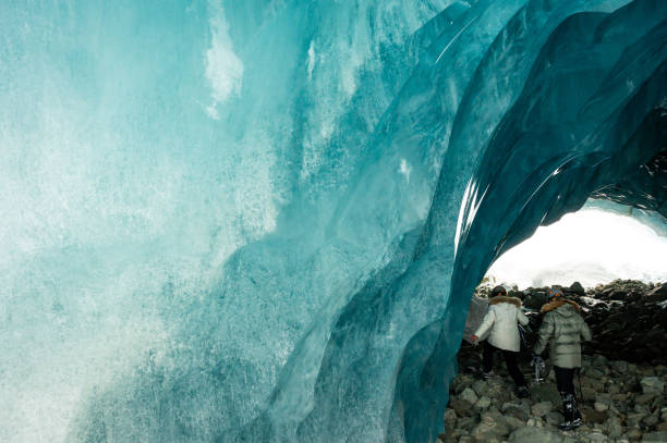 istock Couple visiting a majestic ice cave 1127362496
