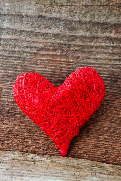 istock Red decoration heart against wooden background 1127362695