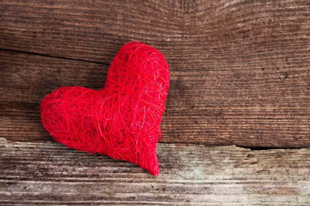 istock Red decoration heart against wooden background 1127363857