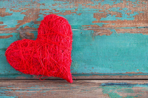 Red decoration heart against wooden background