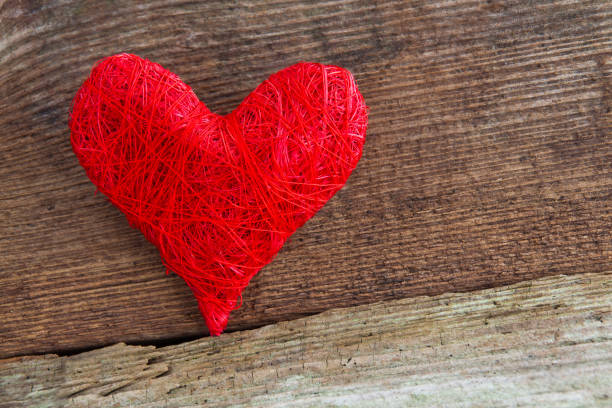 istock Red decoration heart against wooden background 1127364943