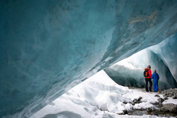 istock Family exploring a stunning glacial ice cave 1127365513