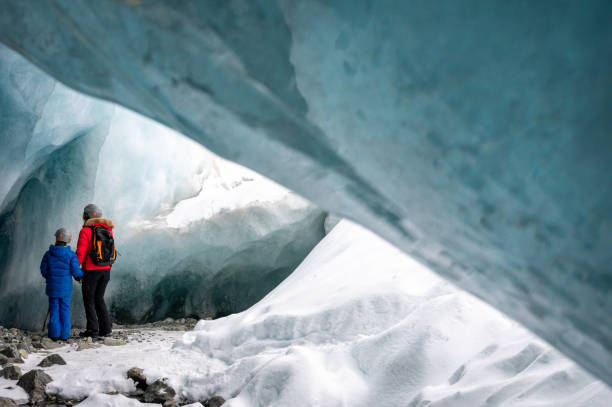 istock Family exploring a stunning glacial ice cave 1127365529