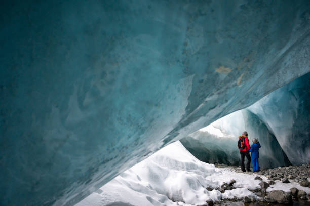 istock Family exploring a stunning glacial ice cave 1127365569