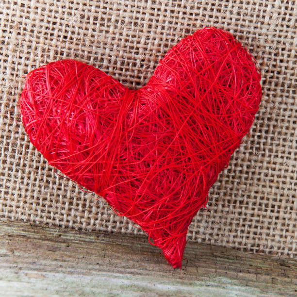 istock Red decoration heart against wooden background 1127365755