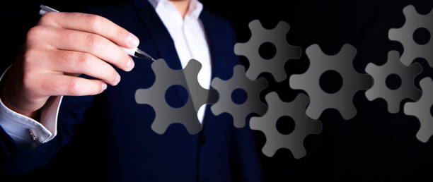 istock businessman and mechanism 1127366018