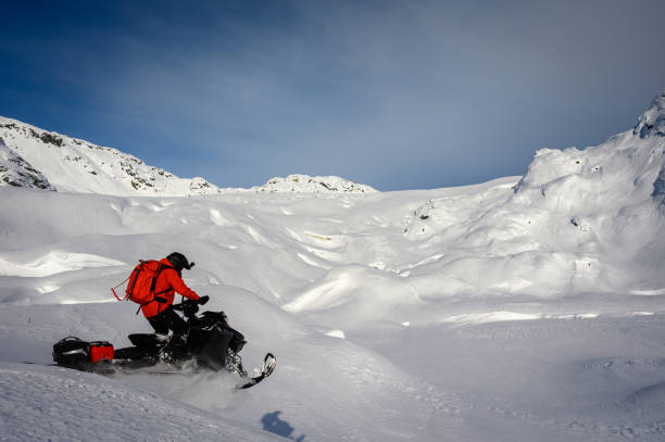 istock Snowmobiling fresh powder in the mountains 1127367087